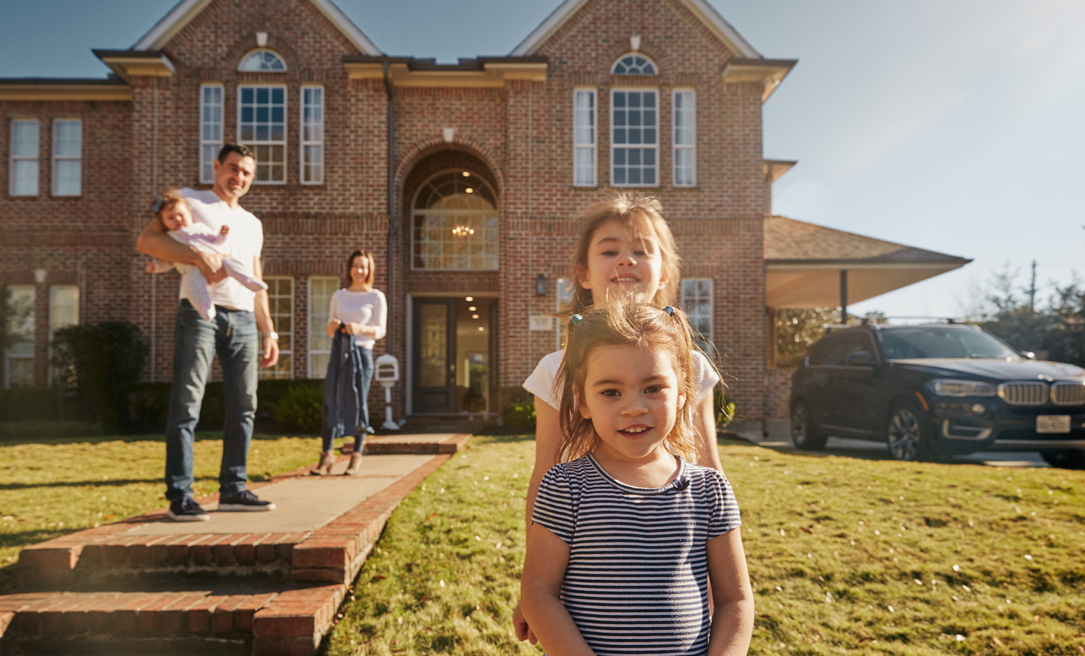 A family standing in front of their house